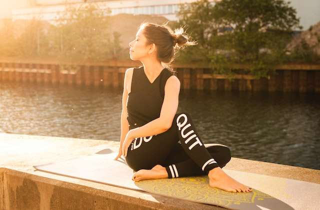 woman doing yoga: caring for your fitness journey
