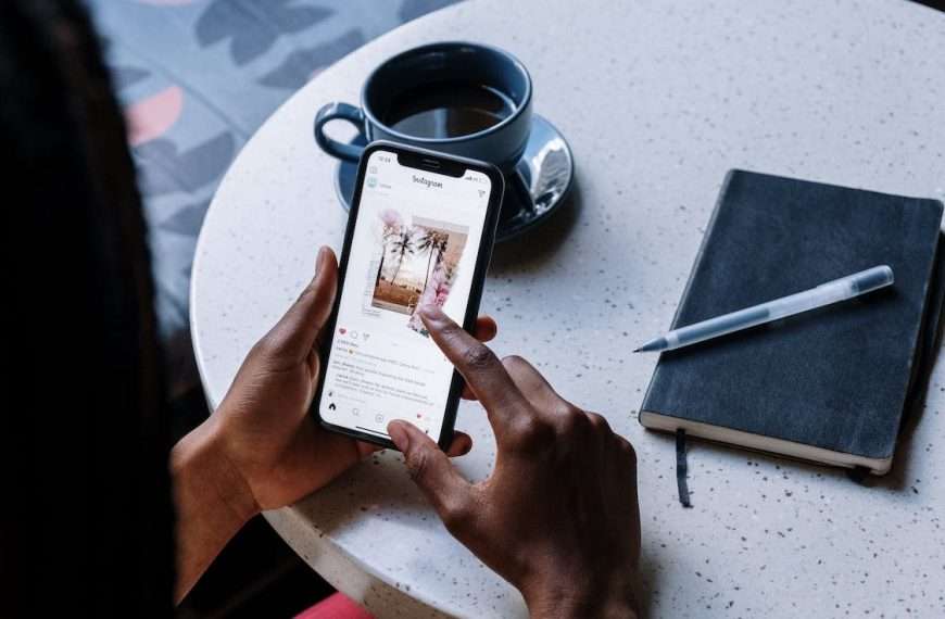Girl looking at social media on her phone: Tips For Posting Holiday Content On Your Social Media