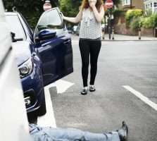 Pedestrian Accident - Person lying on the ground after a car accident