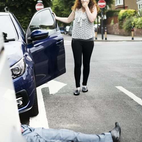 Pedestrian Accident - Person lying on the ground after a car accident
