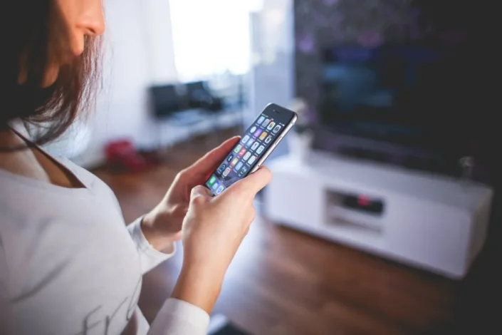 woman with smartphone and smart home