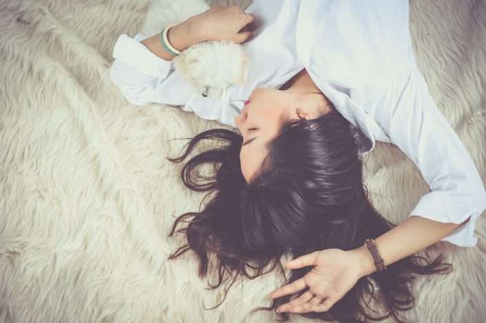 girl asleep on a rug