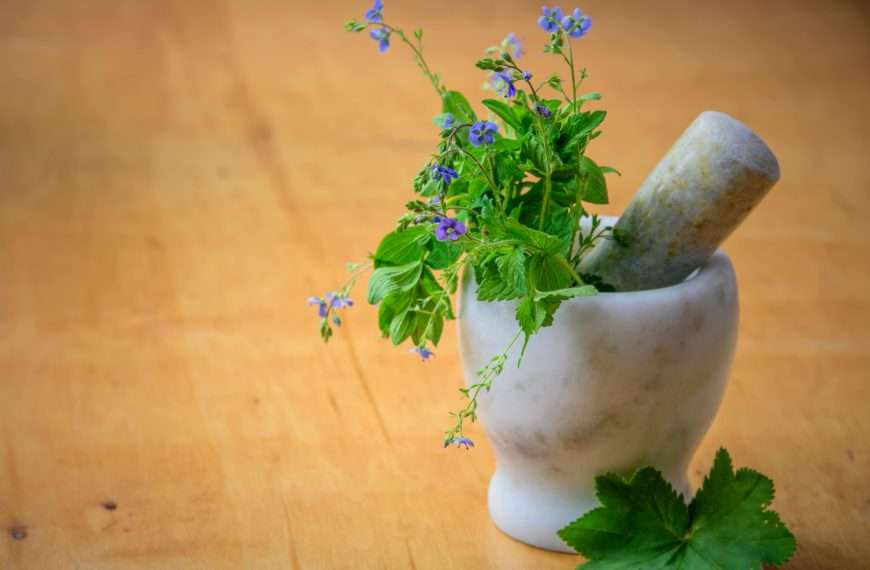 hydrogen water and purple flowers in a mortar and pestle