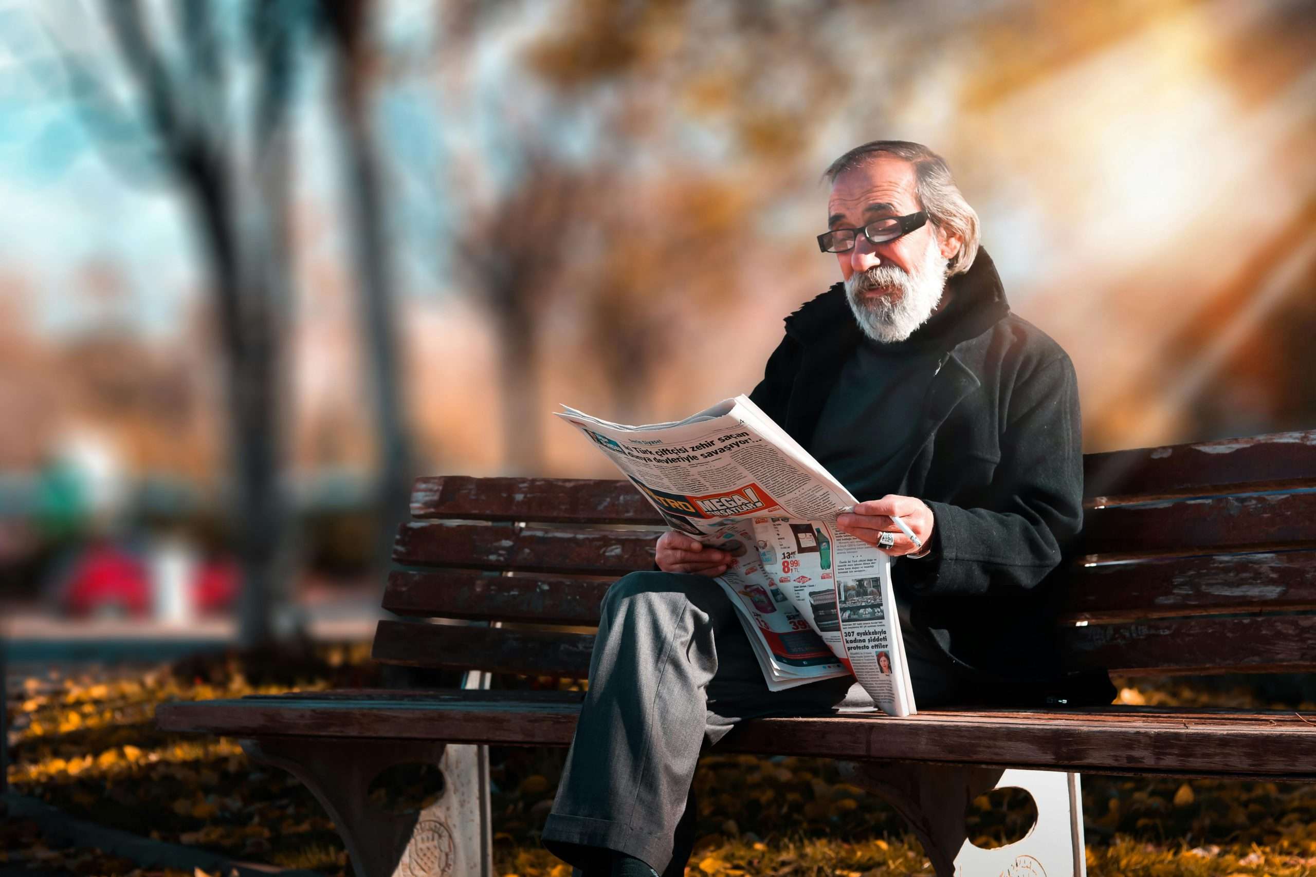 older relatives - man reading newspaper