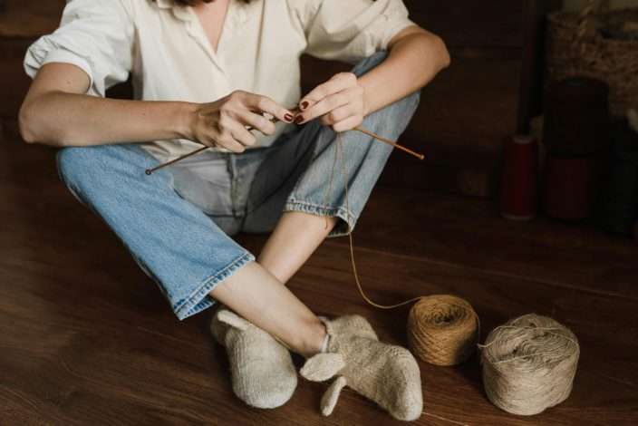 sitting on the floor knitting a craft