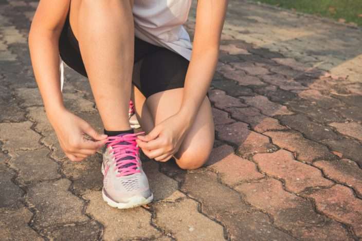 protect your health - woman lacking her shoe to go jogging