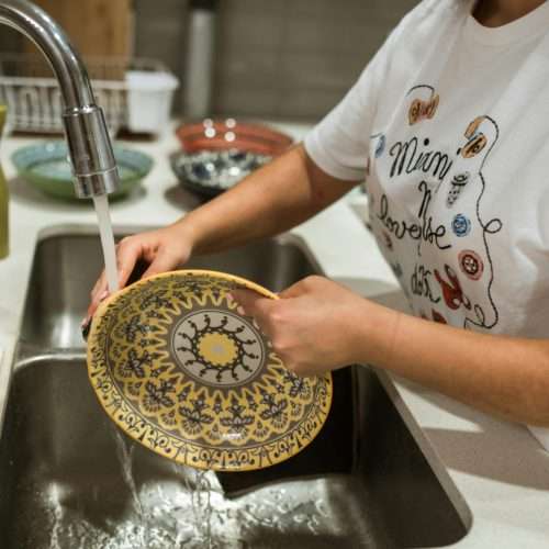 washing dishes with Home Water Filtration Systems