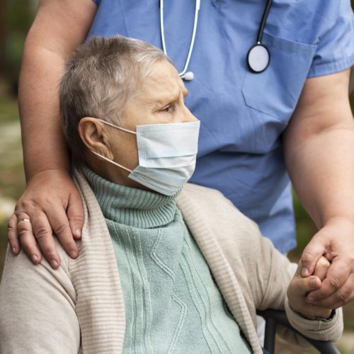 nurse holding the hand of a dementia patient - Dementia Progresses