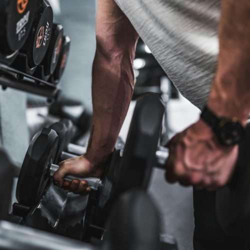 workout - man lifting dumbells