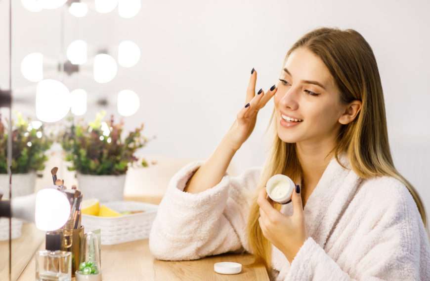 Woman applying Crème Dermopurifiante moisturizer - simplifying your skincare