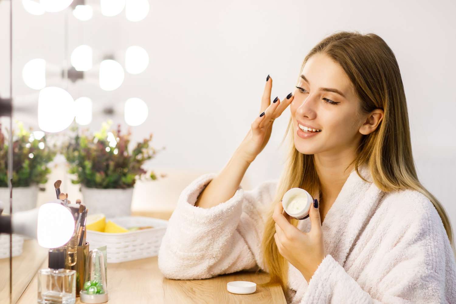 Woman applying Crème Dermopurifiante moisturizer - simplifying your skincare