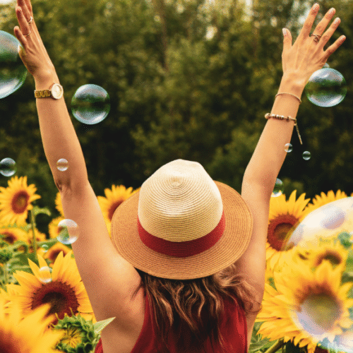 Aesthetic photo of woman with sunflowers and bubbles