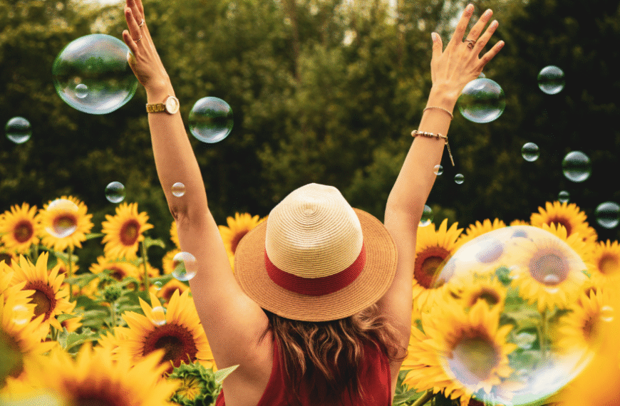 Aesthetic photo of woman with sunflowers and bubbles