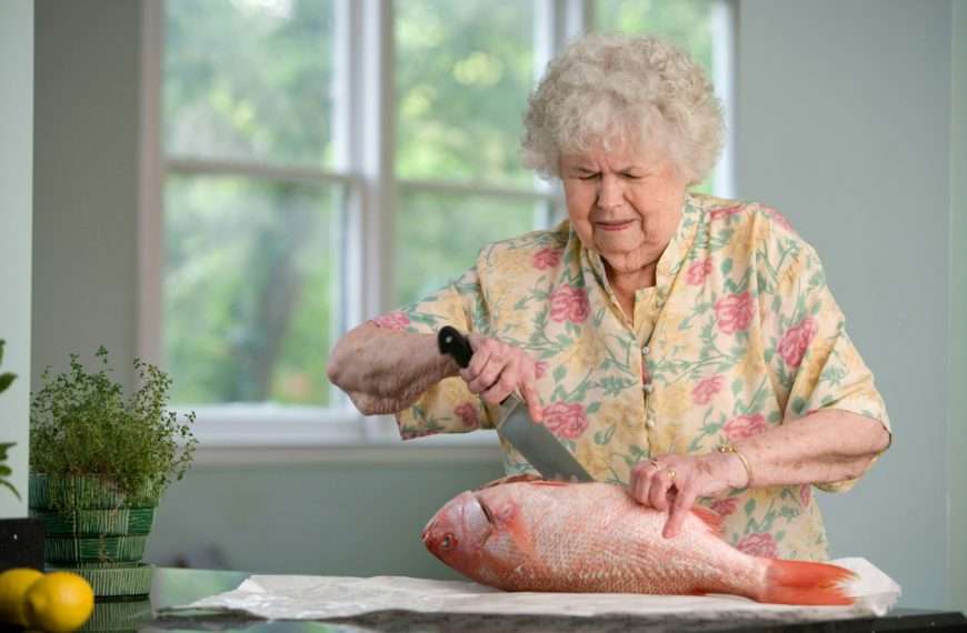 long-term health planning - woman cutting a fish