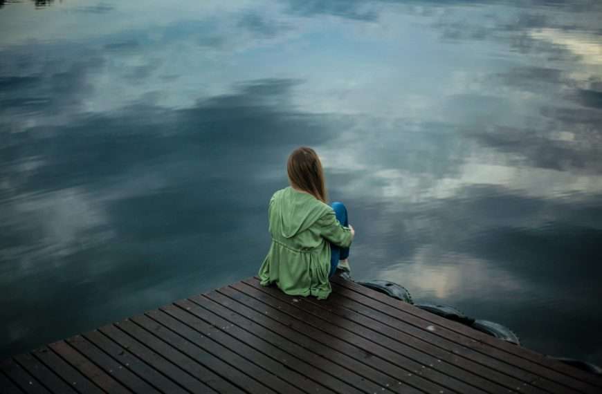 depression - woman sitting on a dock