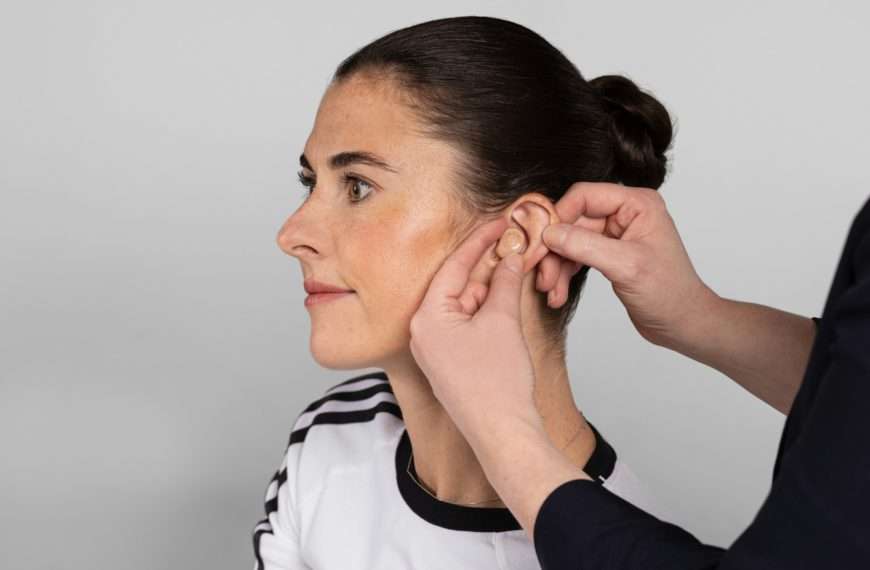 hearing loss - woman getting fitted for a hearing aid