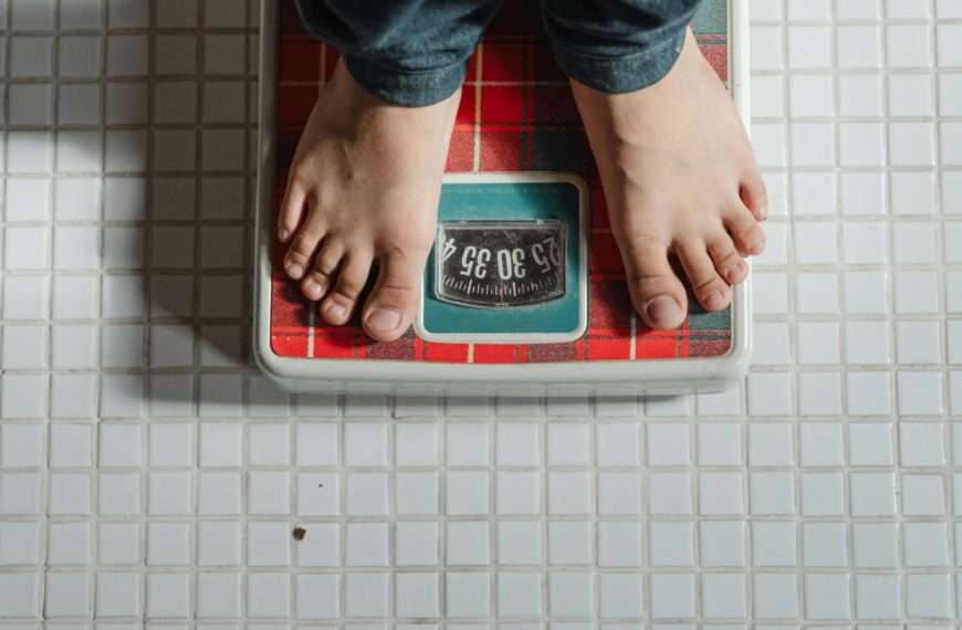weighing on a scale - skin removal after extreme weight loss