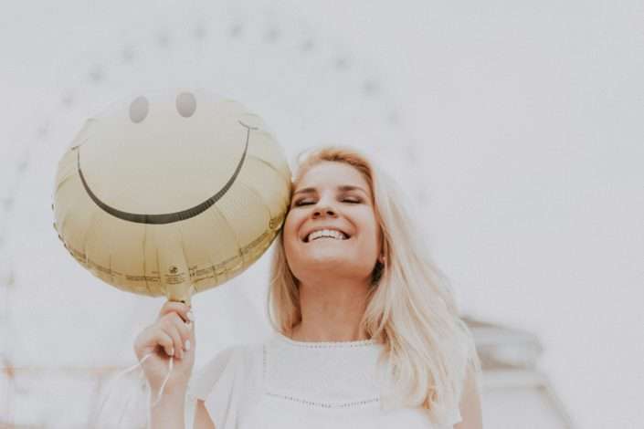 woman holding a balloon - support your mental health