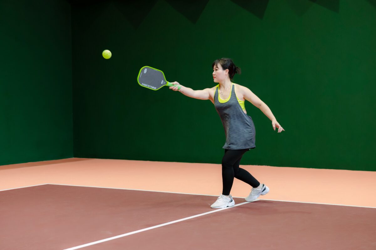 woman playing Pickleball - equipment - net game