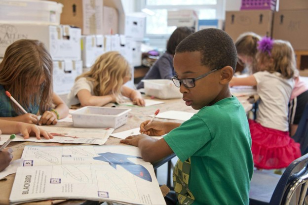 school children completing their workbooks
