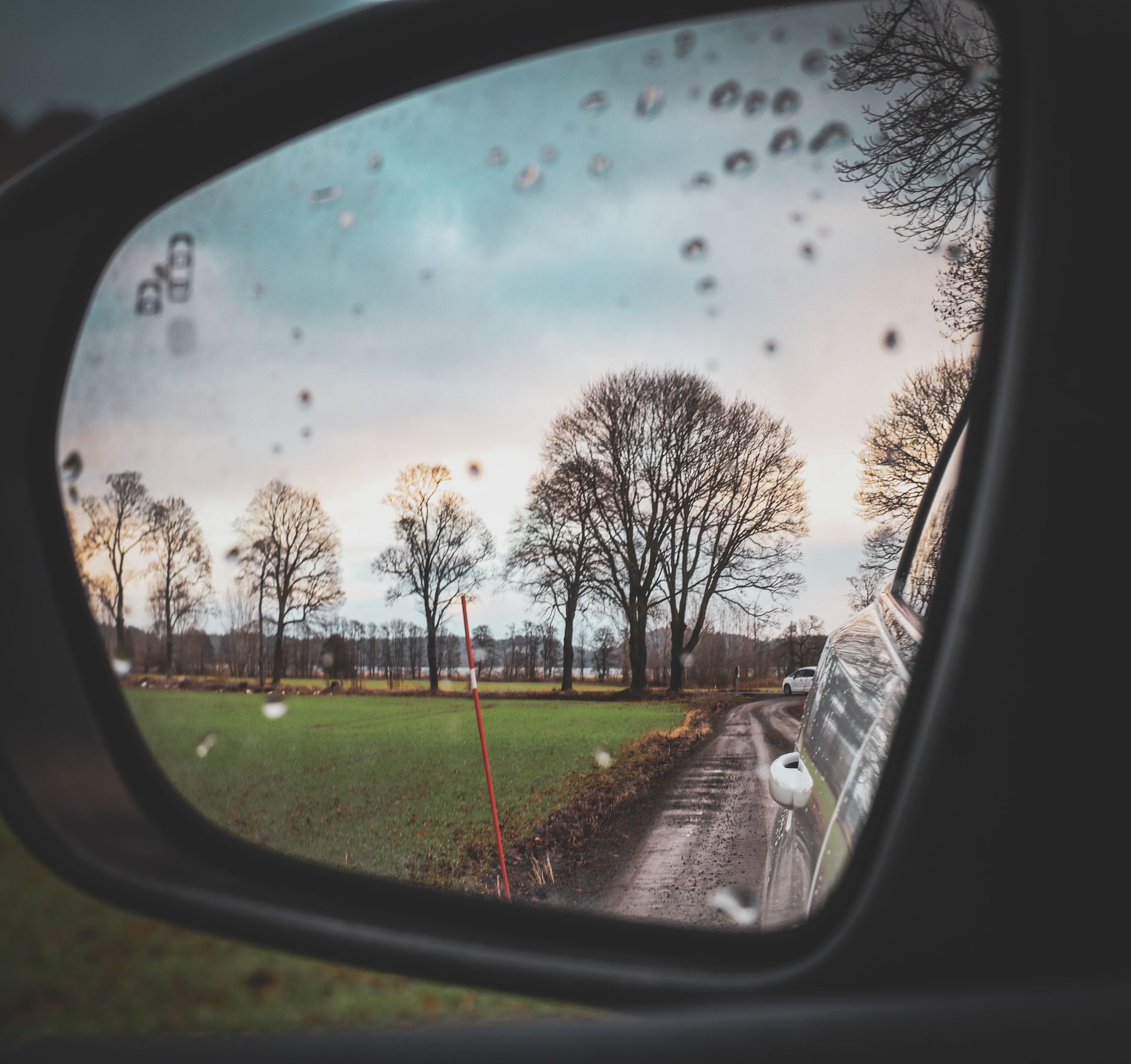 response after a car accident - rain on a car mirror